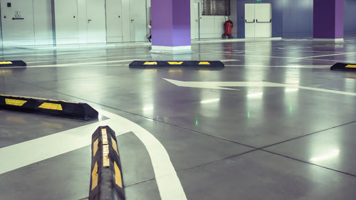 Traffic Management wheel stoppers on concrete flooring